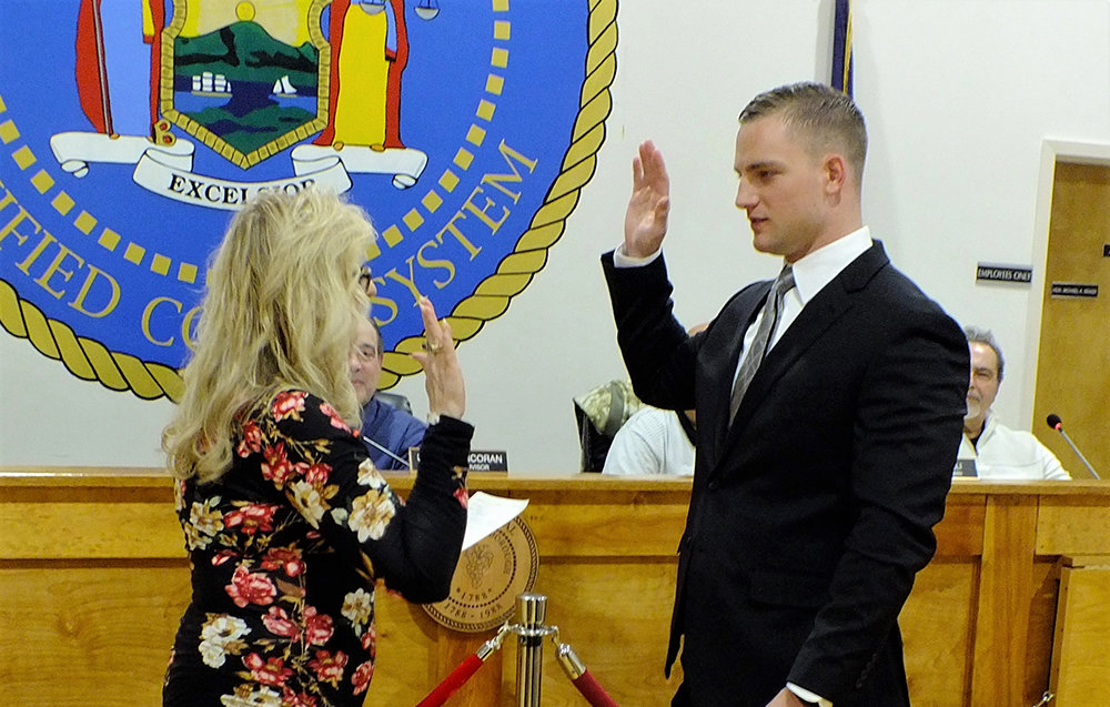 Town Clerk Colleen Corcoran administers the oath of office to Frank Zebrowski.